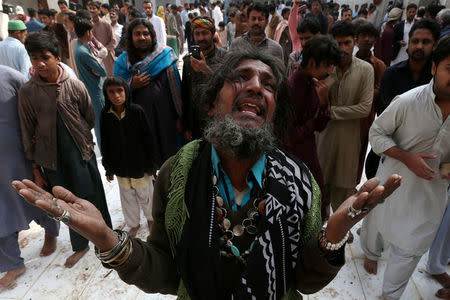 FILE PHOTO - A man mourns the death of a relative who was killed in a suicide blast at the tomb of Sufi saint Syed Usman Marwandi, also known as the Lal Shahbaz Qalandar shrine, on Thursday evening in Sehwan Sharif, Pakistan's southern Sindh province, February 17, 2017. REUTERS/Akhtar Soomro/File Photo