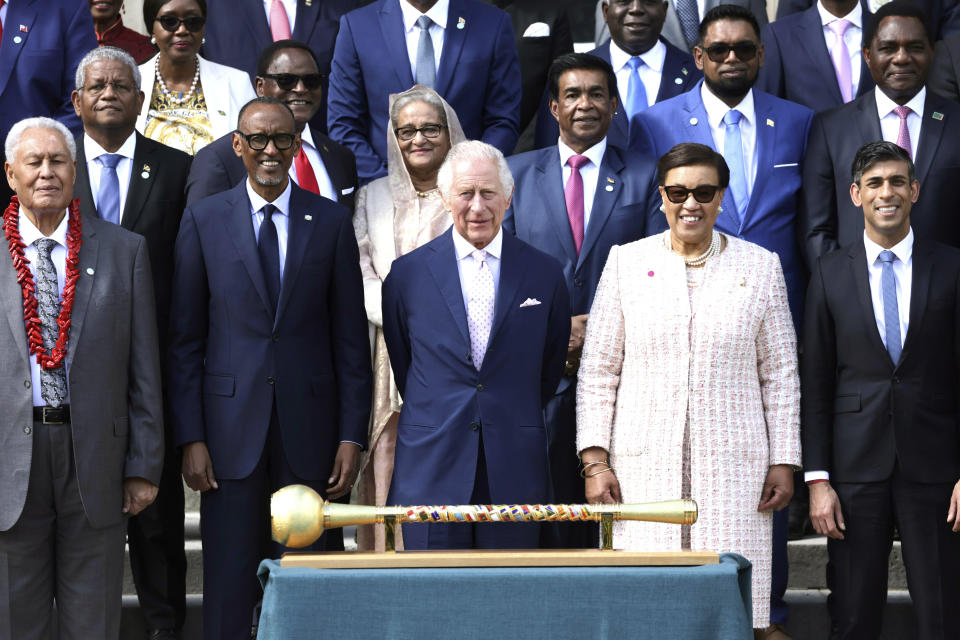 FILE - Britain's King Charles III, center, is flanked by, front row from left; President of Samoa Afioga Tuimalealiifano Vaaletoa Sualauvi II, Rwandan President Paul Kagame, Commonwealth Secretary General Patricia Scotland, and British Prime Minister Rishi Sunak for a group photo at the Commonwealth heads of government leaders meeting at Marlborough House, in London, Friday, May 5, 2023. As head of state the king also hosts world leaders visiting the U.K., and serves as a symbol of national identity, unity and continuity. Every year the monarch leads Remembrance Day ceremonies to honor the war dead, and many watch his annual Christmas Day broadcast. (Chris Jackson/Pool Photo via AP, File)