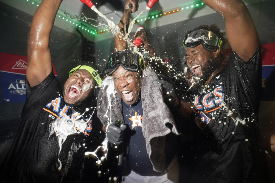 Houston Astros manager Dusty Baker Jr., center, celebrates with pitcher Hector Neris, left, and pitcher Cristian Javier, right, after defeating the Seattle Mariners in Game 3 of an American League Division Series baseball game Saturday, Oct. 15, 2022, in Seattle. (AP Photo/Abbie Parr)