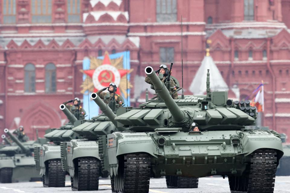 Servicemen salute as their tanks move through Red Square during the Victory Day military parade in Moscow on May 9, 2021. - Russia celebrates the 76th anniversary of the victory over Nazi Germany during World War II. (Photo by Dimitar DILKOFF / AFP) (Photo by DIMITAR DILKOFF/AFP via Getty Images)