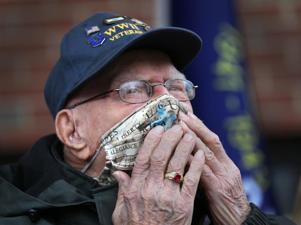 World War II veteran Ray Goulet gives an emotional kiss to a crowd gathered to celebrate his 98th birthday at Margeson Apartments Thursday, Jan. 14, 2021. Goulet was among the first wave of soldiers to storm Omaha Beach in Normandy, France, on D-Day in 1944.