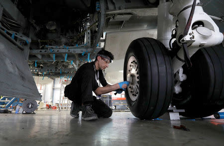 A technician works on a Bombardier Global aircraft at the company's service centre at Biggin Hill, Britain March 5, 2018. REUTERS/Peter Nicholls