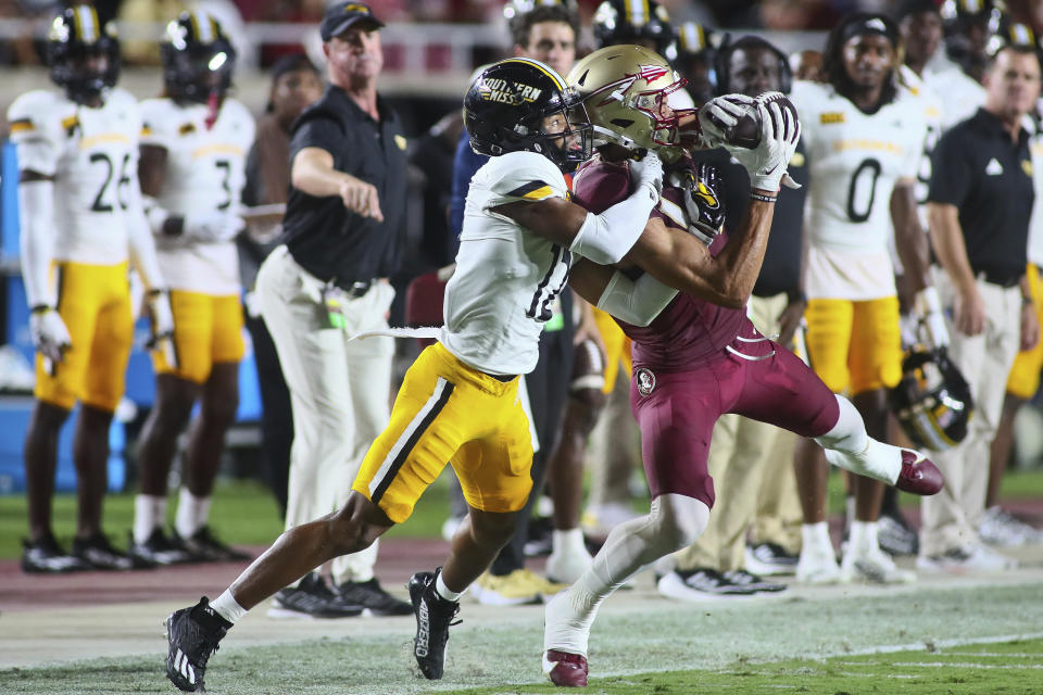 Florida State wide receiver Johnny Wilson, right, catches a pass but was called for offensive pass interference as Southern Mississippi cornerback Ques McNeal, left, defends in the first quarter of an NCAA college football game Saturday, Sept. 9, 2023, in Tallahassee, Fla. (AP Photo/Phil Sears)