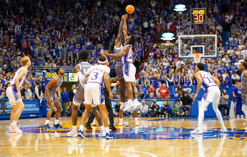 Seton Hall Pirates forward Tyrese Samuel (4) and Kansas Jayhawks forward K.J. Adams Jr. (24) battle for the opening jump ball during the first half at Allen Fieldhouse.