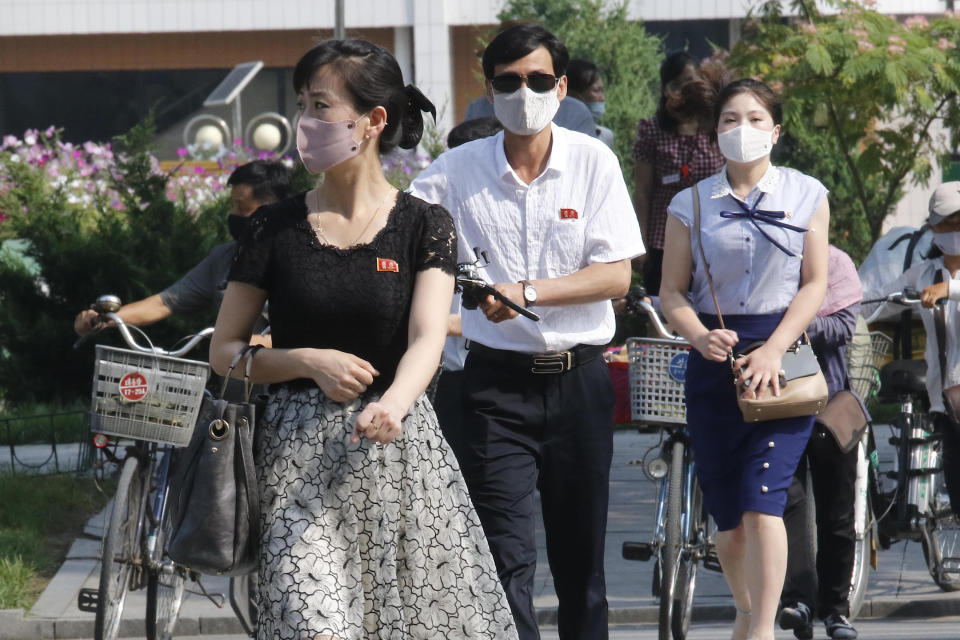 People wearing masks walk in the Ryomyong street in Pyongyang, North Korea Friday, July 3, 2020. North Korean leader Kim Jong Un urged officials to maintain alertness against the coronavirus, warning that complacency risked “unimaginable and irretrievable crisis,” state media said Friday. (AP Photo/Jon Chol Jin)