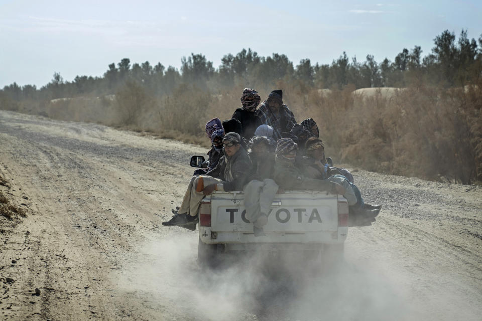 Afghan refugees sit in the back of a truck to go to Iran through the desert after crossing the borders of Afghanistan and Pakistan, on the outskirts of Zaranj city, Afghanistan, Sunday, Dec. 24, 2023. More than 40 years of war, violence and poverty in Afghanistan have created one of the world’s most uprooted populations. (AP Photo/Ebrahim Noroozi)