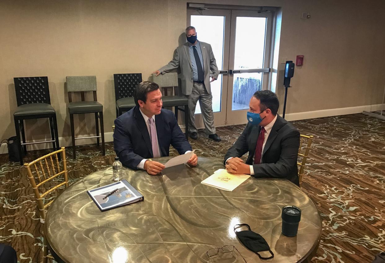 In this 2020 photo, Gov. Ron DeSantis meets with then-Palm Beach County Mayor Dave Kerner at the National Fraternal Order of Police Fall Board Meeting in Atlantic Beach.