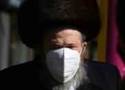 A Hasidic Jewish man wears a N-95 face mask in the Borough Park section of Brooklyn, New York on October 9, 2020