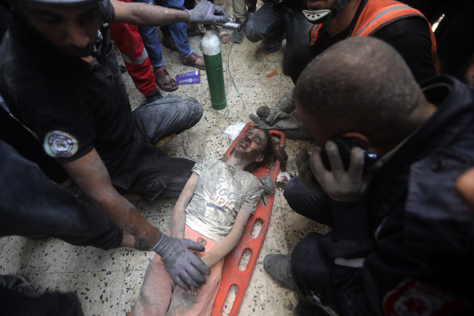 Palestinians rescue a wounded girl from under the rubble of a destroyed building following an Israeli airstrike in Khan Younis refugee camp, southern Gaza Strip, Tuesday, Nov. 7, 2023. (AP Photo/Mohammed Dahman)