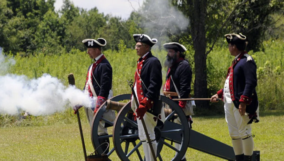 Reenactors as Continental soldiers fire a replica cannon at the Cowpens Battlefield as part of a Fourth of July celebration.