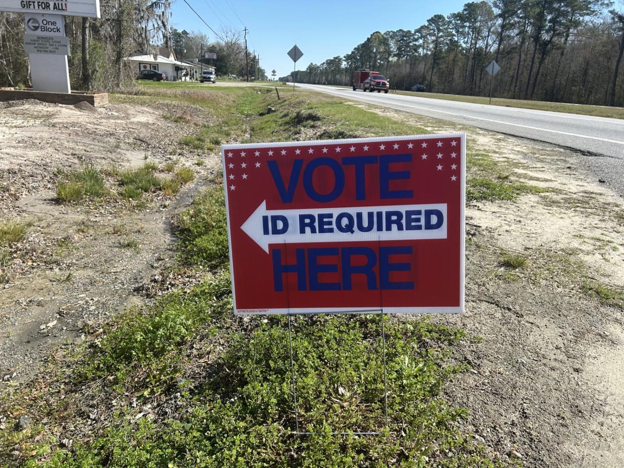A "Vote Here" sign sits on the edge of Highway 17 in Richmond Hill during the presidential primary.