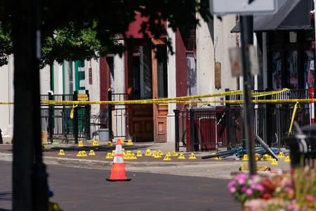 Evidence markers rest on the ground after a mass shooting in Dayton