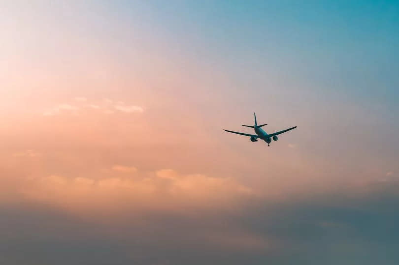 Aircraft flying over clouds, aviation sunset background, essential transport for business and travel..