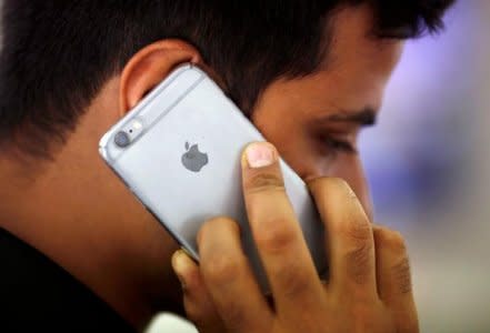 FILE PHOTO: A man talks on his iPhone at a mobile phone store in New Delhi, India, July 27, 2016. REUTERS/Adnan Abidi/File photo