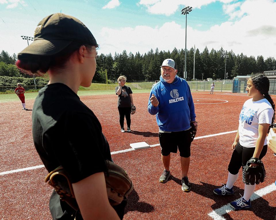 Olympic softball head coach Chuck Stark gives instructions to his team as the start practice on Wednesday, May 25, 2022.