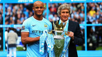 Vincent Kompany and Manuel Pellegrini pose with the EPL trophy in 2013-14. Image: Getty