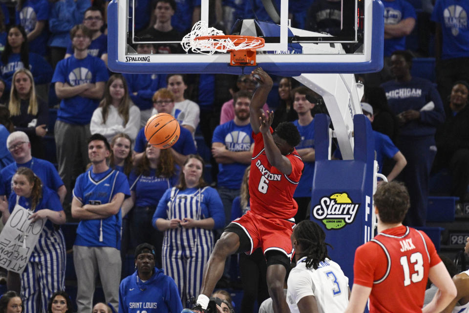 Dayton's Enoch Cheeks dunks, left, against Saint Louis' Bradley Ezewiro during the second half of an NCAA college basketball game Tuesday, March 5, 2024, in St. Louis. (AP Photo/Joe Puetz)