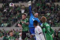 Austin FC goalkeeper Brad Stuver, center, and defender Zan Kolmanic (23) defender defend a shot on goal by St Louis City FC during the first half of an MLS soccer match in Austin, Texas, Saturday, Feb. 25, 2023. (AP Photo/Eric Gay)