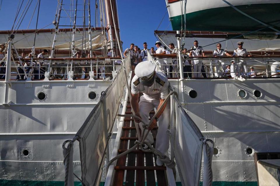 An officer unties a knot as sailors dock the The Navy School Ship “Juan Sebastián de Elcano” at Maurice A. Ferré Park.