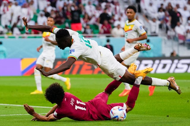 Qatar were denied a first-half penalty after Akram Afif went down to Ismaila Sarr's challenge