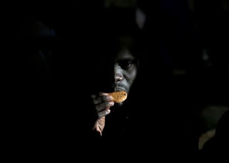 A migrant eats a biscuit on the Migrant Offshore Aid Station (MOAS) ship Topaz Responder after being rescued around 20 nautical miles off the coast of Libya, June 23, 2016. Picture taken June 23, 2016.REUTERS/Darrin Zammit Lupi