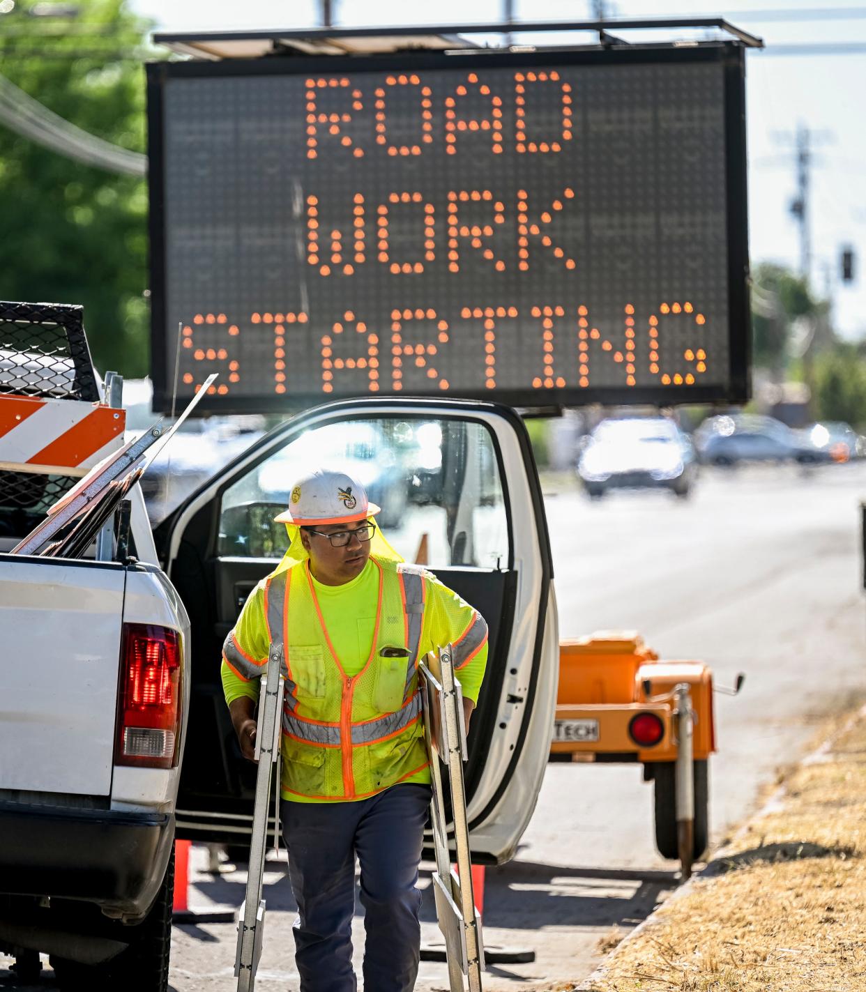 Xavier Cuellar of Safety Network places signs Tuesday, May 17, 2022, for the Battery Backup System & Traffic Signal Preemption Project on Murray Avenue between Encina and Giddings streets.