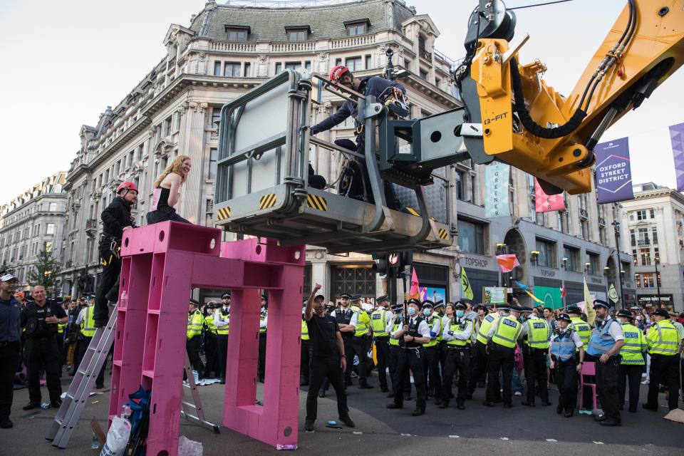 Police officers remove an Extinction Rebellion activist who had taken part in a pink roadblock of Oxford Circus by women and FINT-identifying environmental activists during the third day of Impossible Rebellion protests on 25th August 2021 in London, United Kingdom. Extinction Rebellion are calling on the UK government to cease all new fossil fuel investment with immediate effect. (photo by Mark Kerrison/In Pictures via Getty Images)