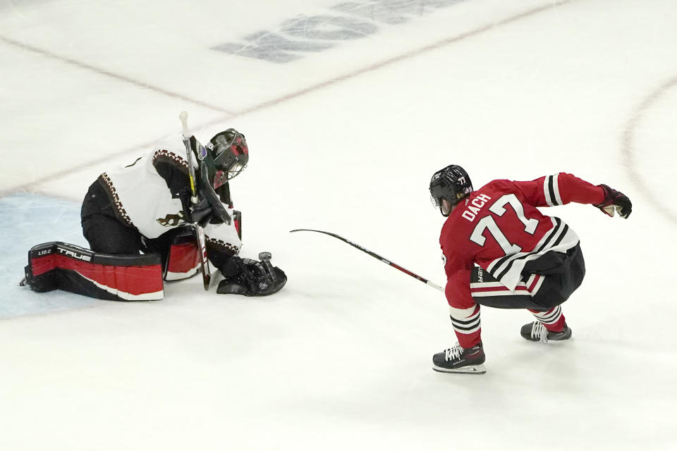 Arizona Coyotes goalie Scott Wedgewood, left, make a save on a shot by Chicago Blackhawks' Kirby Dach during the third period of an NHL hockey game Friday, Nov. 12, 2021, in Chicago. The Blackhawks won 2-1. (AP Photo/Charles Rex Arbogast)