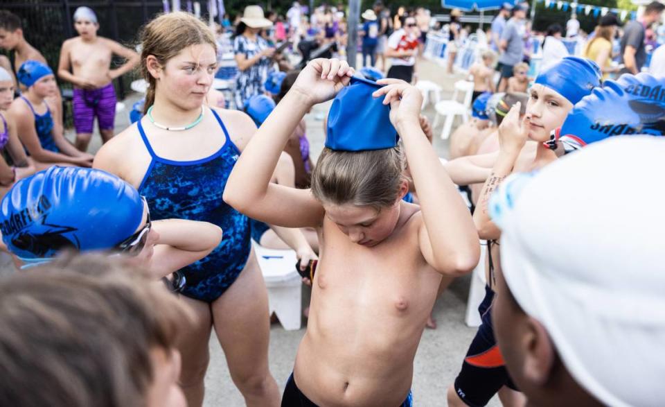 Mike Dumas adjusts his goggles before his swim meet for his neighborhood swim team. He competes for the boys team and is often one of the better swimmers. Mike is a 12-year-old transgender, and wants to continue gender-affirming care. NC lawmakers are trying to stop it.