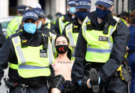 SENSITIVE MATERIAL. THIS IMAGE MAY OFFEND OR DISTURB Police officers remove an Extinction Rebellion climate activist after they had attached themselves to the Houses of Parliament, during a protest in London, Britain, September 10, 2020. REUTERS/Toby Melville
