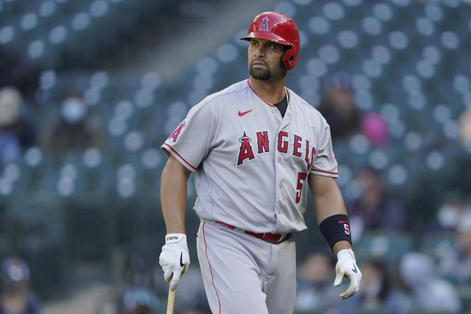 Los Angeles Angels Albert Pujols walks to the dugout after he was called out on strikes during the ninth inning of a baseball game against the Seattle Mariners, Sunday, May 2, 2021, in Seattle. (AP Photo/Ted S. Warren)