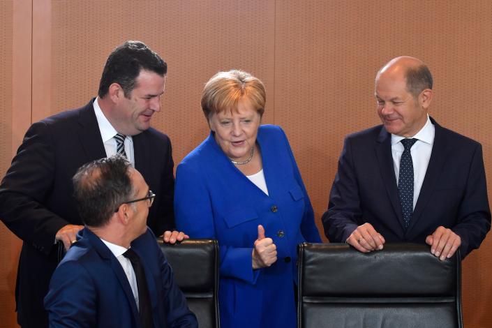 German Chancellor Angela Merkel (2nd R) gives a thumbs up as she talks with German Finance Minister and Vice-Chancellor Olaf Scholz (R), German Foreign Minister Heiko Maas (L, sitting) and German Labour Minister Hubertus Heil prior to the weekly cabinet meeting on August 21, 2019 at the Chancellery in Berlin. Photo: JOHN MACDOUGALL/AFP via Getty Images