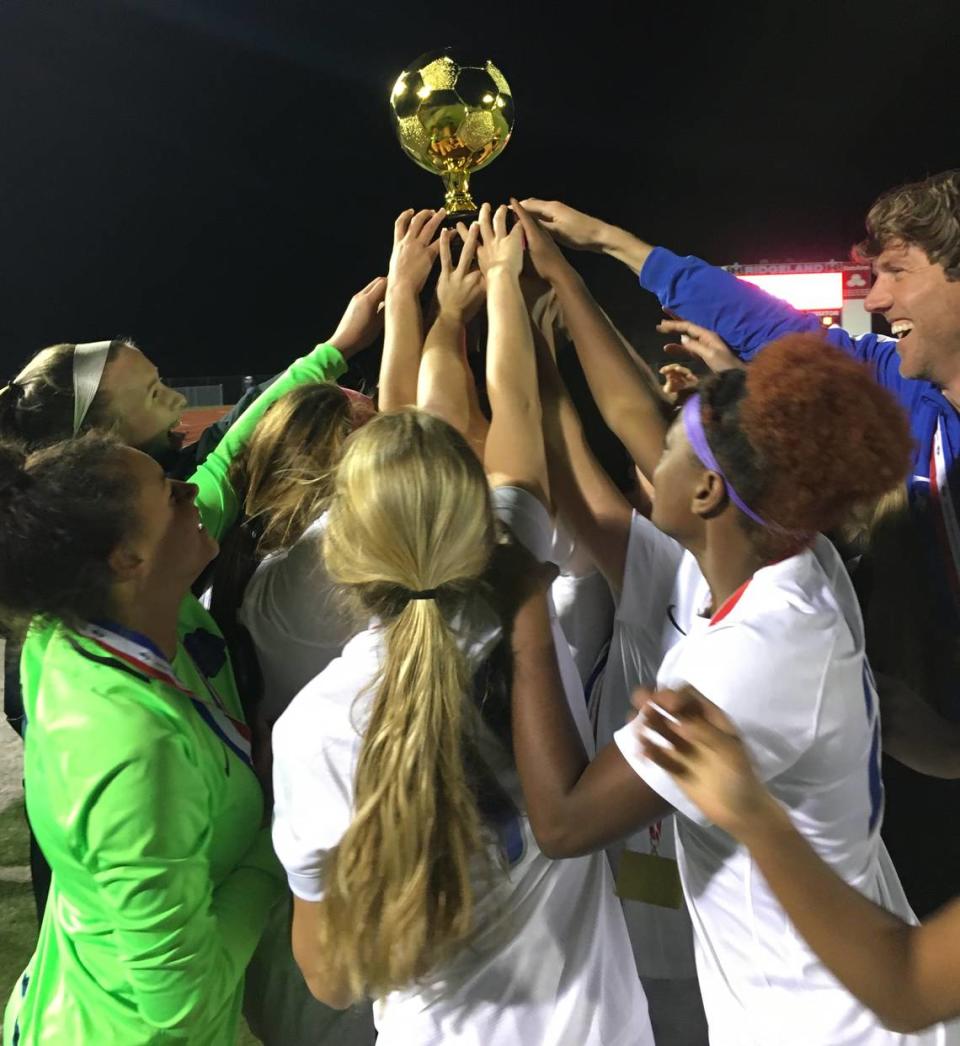 The Ocean Springs girls soccer team celebrates after beating Madison Central on penalty kicks to claim the Class 6A state championship at Ridgeland.