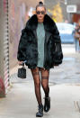 <p>To hit the N.Y.C. streets, the model paired a light green oversize T-shirt with sheer Alexander Wang tights featuring the word "girls" on the front of both legs. She topped off her look with a black fur coat, chunky combat boots, and delicate gold jewels.</p>