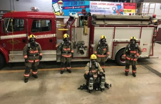 Firefighters with the South Bruce Fire Rescue service pose in new gear purchased by the NWMO, which is spending millions in the community on everything from playgrounds to finding rural doctors with its 'goodwill' fund. 