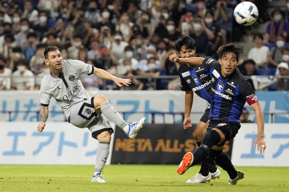 FILE - Paris Saint-Germain's Lionel Messi tries to shoot against Gamba Osaka's Ryu Takao and Gen Shoji during a friendly soccer match between Paris Saint-Germain and Gamba Osaka in Suita, western Japan, on July 25, 2022. (AP Photo/Hiro Komae, File)