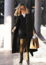 <p>While Khloe’s black top, trench coat and leggings aren’t anything to write home about, her thigh-high brown suede boots and matching crocodile Birkin bag are! (Photo: Splash)</p>