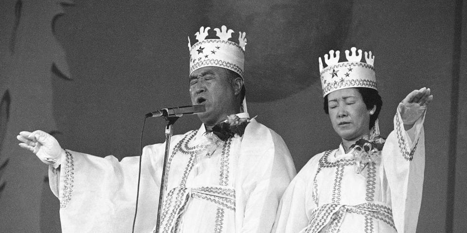 In this Oct. 14, 1982 file photo, Rev. Sun Myung Moon, left, and his wife Hak Ja Han, are shown during the traditional invocation of a blessing at a mass wedding in Seoul’s Chamsil gymnasium where 6,000 couples from about 80 countries were married.