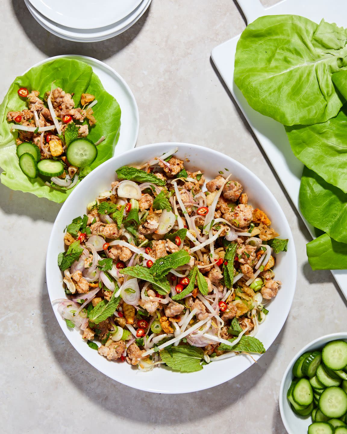 lamb gai garnished with mint in a white bowl