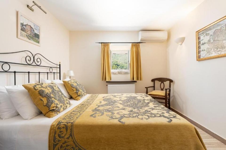 <p>Located in a 14th-century Venetian village of Old Perithia on Corfu, this small but elegant boutique guesthouse is a great alternative to the beach sprawls the island is known for. Housed in a fully restored 17th-century building, once a tradesman's bazaar, the rustic-chic <a href="https://www.booking.com/hotel/gr/the-merchants-house.en-gb.html?aid=1922306&label=best-hotels-greece" rel="nofollow noopener" target="_blank" data-ylk="slk:Merchant's House;elm:context_link;itc:0;sec:content-canvas" class="link ">Merchant's House</a> has just six suites, all with a refined vibe: think beamed ceilings, cast iron beds and dark wood furnishings. Breakfast is served in the courtyard garden and while there isn't a restaurant, the hotel is within walking distance of a handful of excellent tavernas in the village.</p><p>There's plenty to see nearby, including the Megali Grava cave. While the highest mountain on Corfu, Mount Pantokrator, is right on the doorstep, offering some of the island's best hiking and cycling trails.</p><p><a class="link " href="https://www.booking.com/hotel/gr/the-merchants-house.en-gb.html?aid=1922306&label=best-hotels-greece" rel="nofollow noopener" target="_blank" data-ylk="slk:CHECK AVAILABILITY;elm:context_link;itc:0;sec:content-canvas">CHECK AVAILABILITY</a></p>