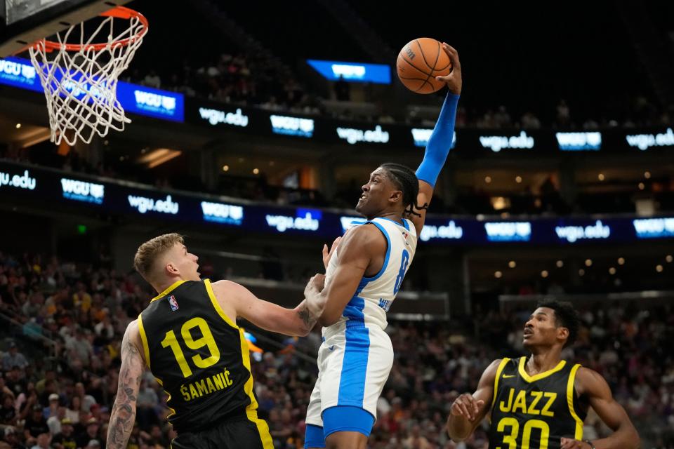 Thunder forward Jalen Williams (8) goes to the basket for a dunk over Jazz forward Luka Samanic (19) in the first half of OKC's 95-85 win Monday night in Salt Lake City.