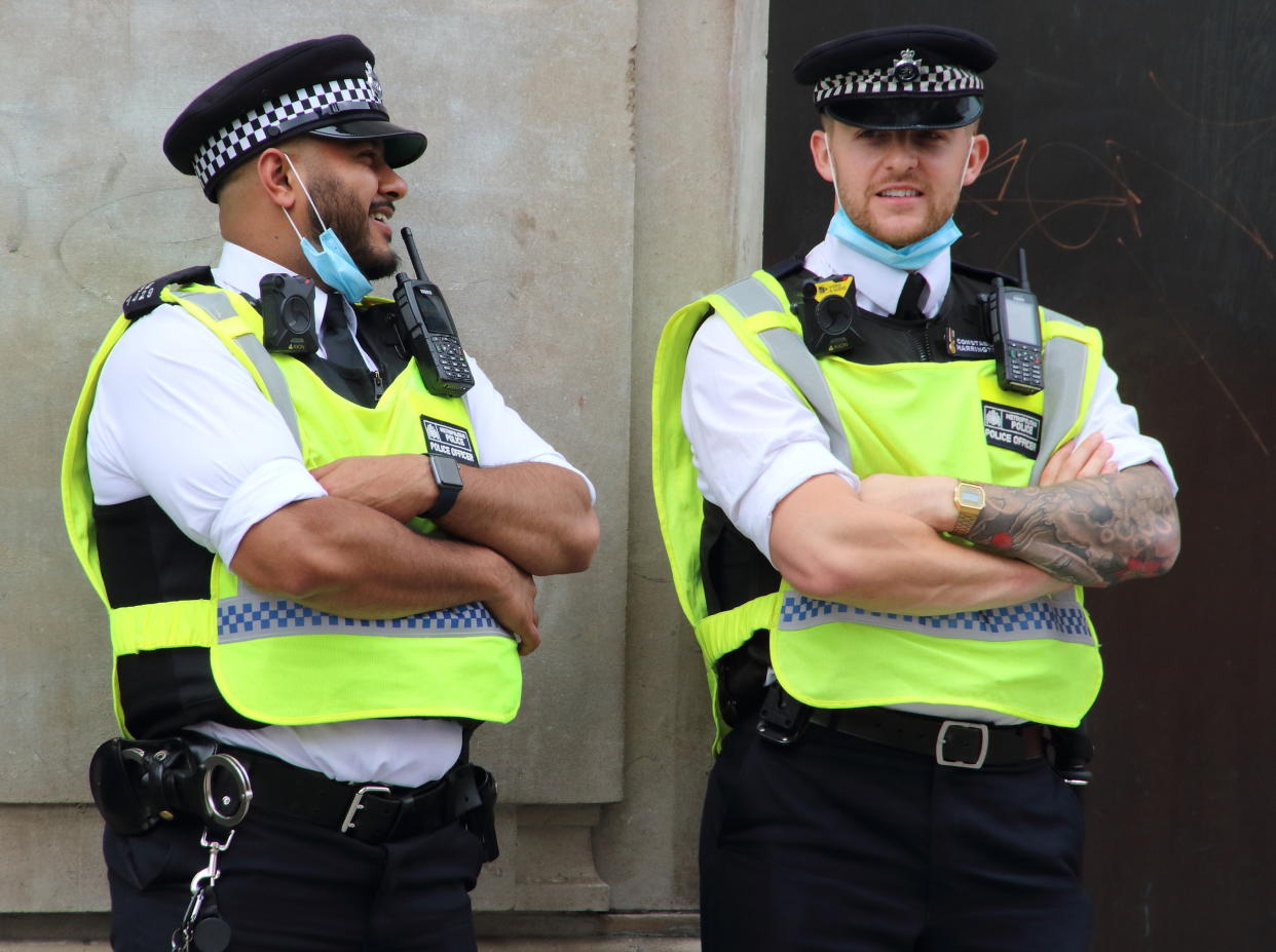  Police officers are seen with pulled down facemasks as they relax. A change in policy has meant that in some situations where social distancing is impossible, Police at demonstrations will wear Protective face masks. A spokesperson said: "If officers cannot maintain a two metre gap and where there is a possible risk of infection, our policy is now that officers will wear a facemask, which all officers have readily available." (Photo by Keith Mayhew / SOPA Images/Sipa USA) 