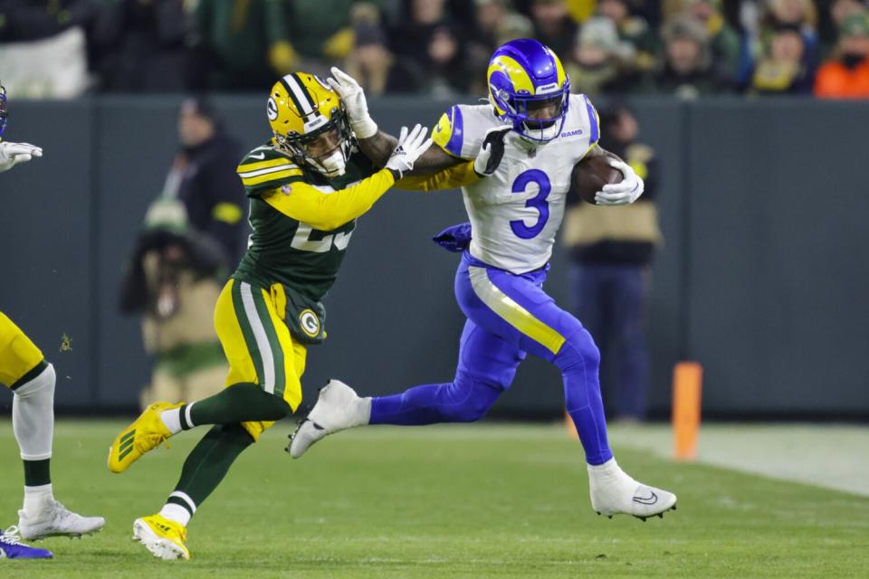 Rams running back Cam Akers (3) gives Packers cornerback Jaire Alexander (23) a straight arm.