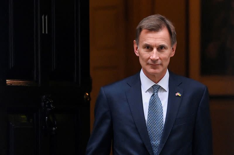 FILE PHOTO: Britain's Chancellor of the Exchequer Jeremy Hunt walks at Downing Street in London