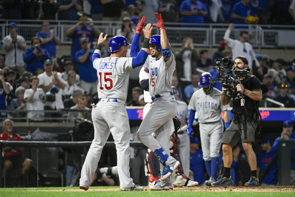 Chicago Cubs' Christopher Morel (5) celebrates with teammate Yan Gomes (15) after hitting a two-run home run to drive them in against the Minnesota Timberwolves during the ninth inning of a baseball game, Friday, May 12, 2023, in Minneapolis. (AP Photo/Craig Lassig)