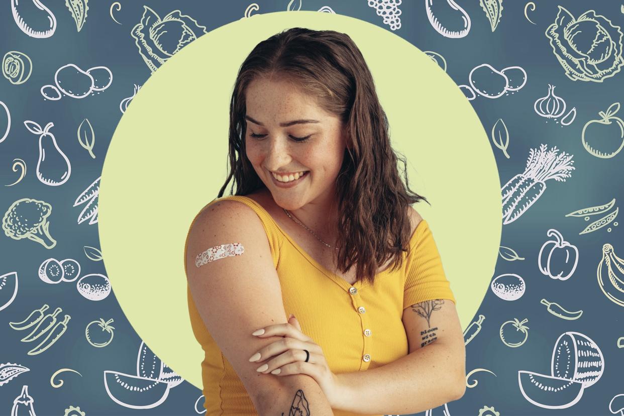 a woman showing where on her arm she received her flu shot vaccine