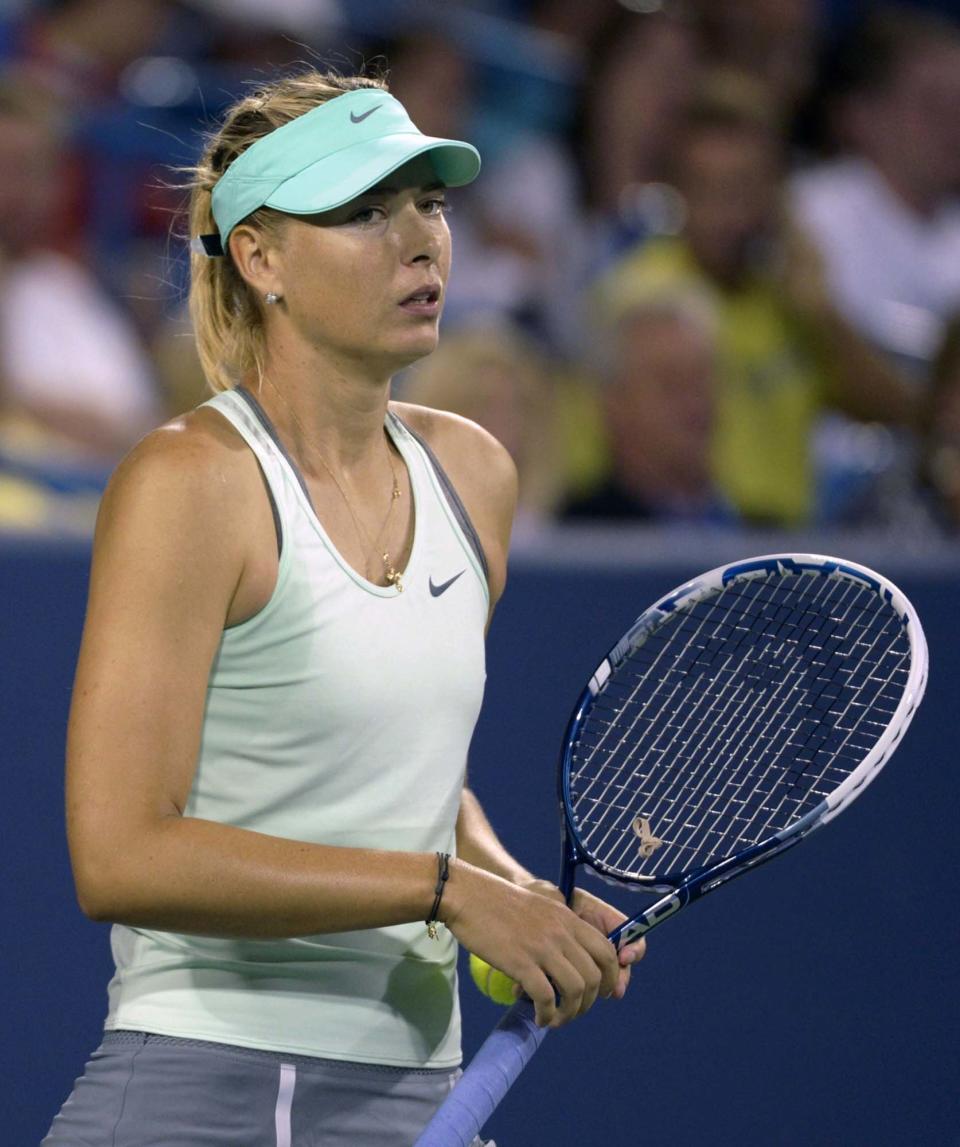 Maria Sharapova, from Russia, reacts while losing in an upset to Sloane Stephens, from the United States, in a match at the Western & Southern Open tennis tournament, Tuesday, August 13, 2013, in Mason, Ohio. (AP Photo/Michael E. Keating)