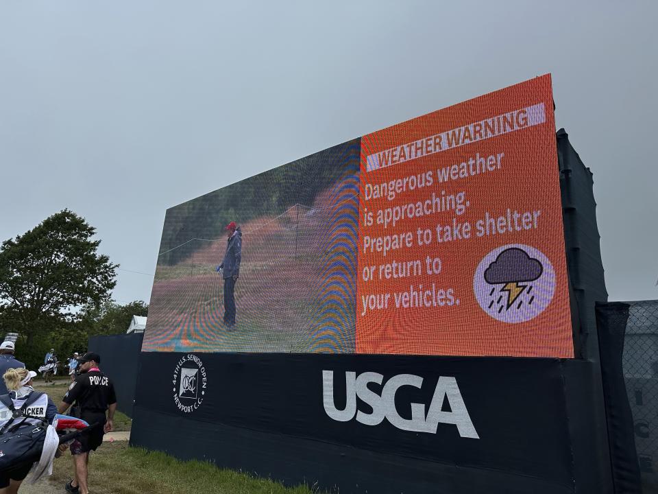 A sign warns fans to take shelter as severe weather forces a delay in the final round of the U.S. Senior Open golf tournament in Newport, R.I., Sunday, June 30, 2024. (AP Photo/Jimmy Golen)