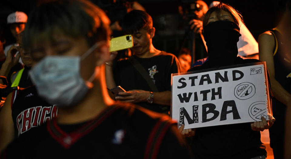 A protester holds a sign at the Southorn Playground in Hong Kong on October 15, 2019, during a rally in support of NBA basketball Rockets general manager Daryl Morey and against comments made by Lakers superstar LeBron James. - US basketball superstar LeBron James on October 14, 2019, has sharply criticised a Houston Rockets executive for angering China with a tweet supporting protesters in Hong Kong, saying the executive was "misinformed" and should have kept his mouth shut. (Photo by Anthony WALLACE / AFP) (Photo by ANTHONY WALLACE/AFP via Getty Images)