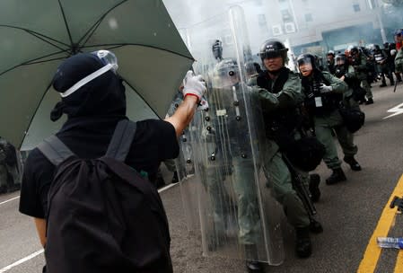 Demonstrators clash with police during a protest against the Yuen Long attacks in Yuen Long, New Territories, Hong Kong